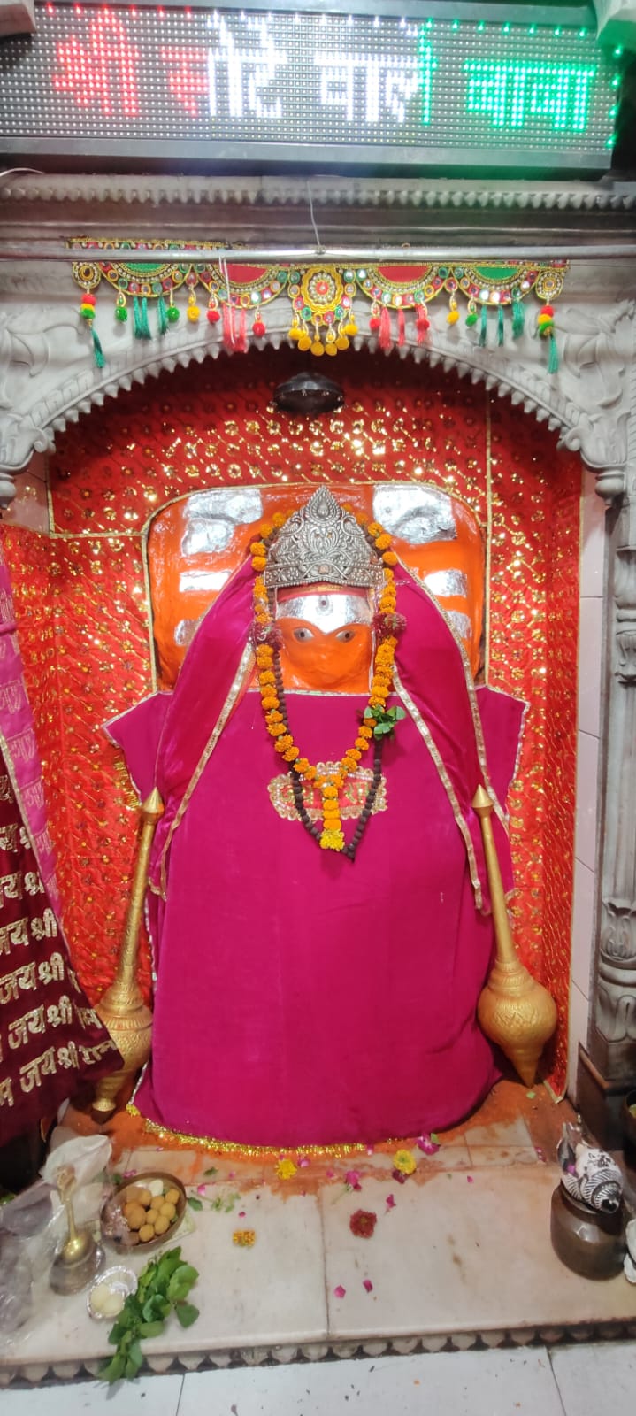 Baba in pink chola inside the garbhagriha